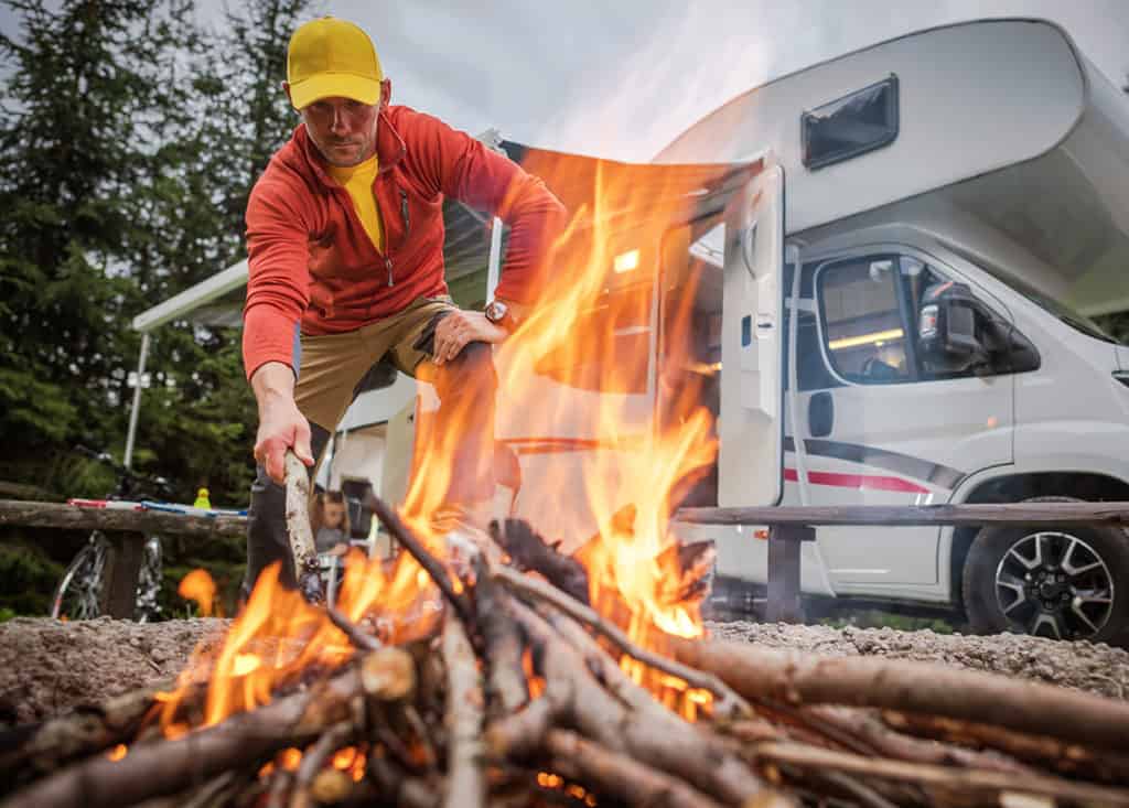 Man enjoying a fire at McGregor's RV Camp